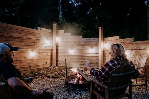 Couple sitting outside by a fire pit at the Cozy Cabin