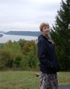 Joyce Brinkman standing in front of a lake
