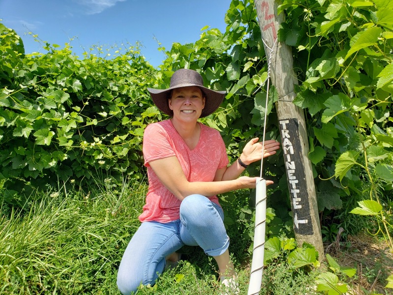 Lady pointing to sign in East Winery field