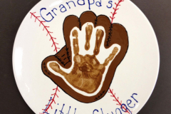 A hand print and baseball pattern on plate