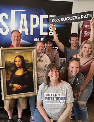 People posing with Mona Lisa after Escape Room