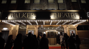 Outside of theater with sign saying "Walker Theatre"