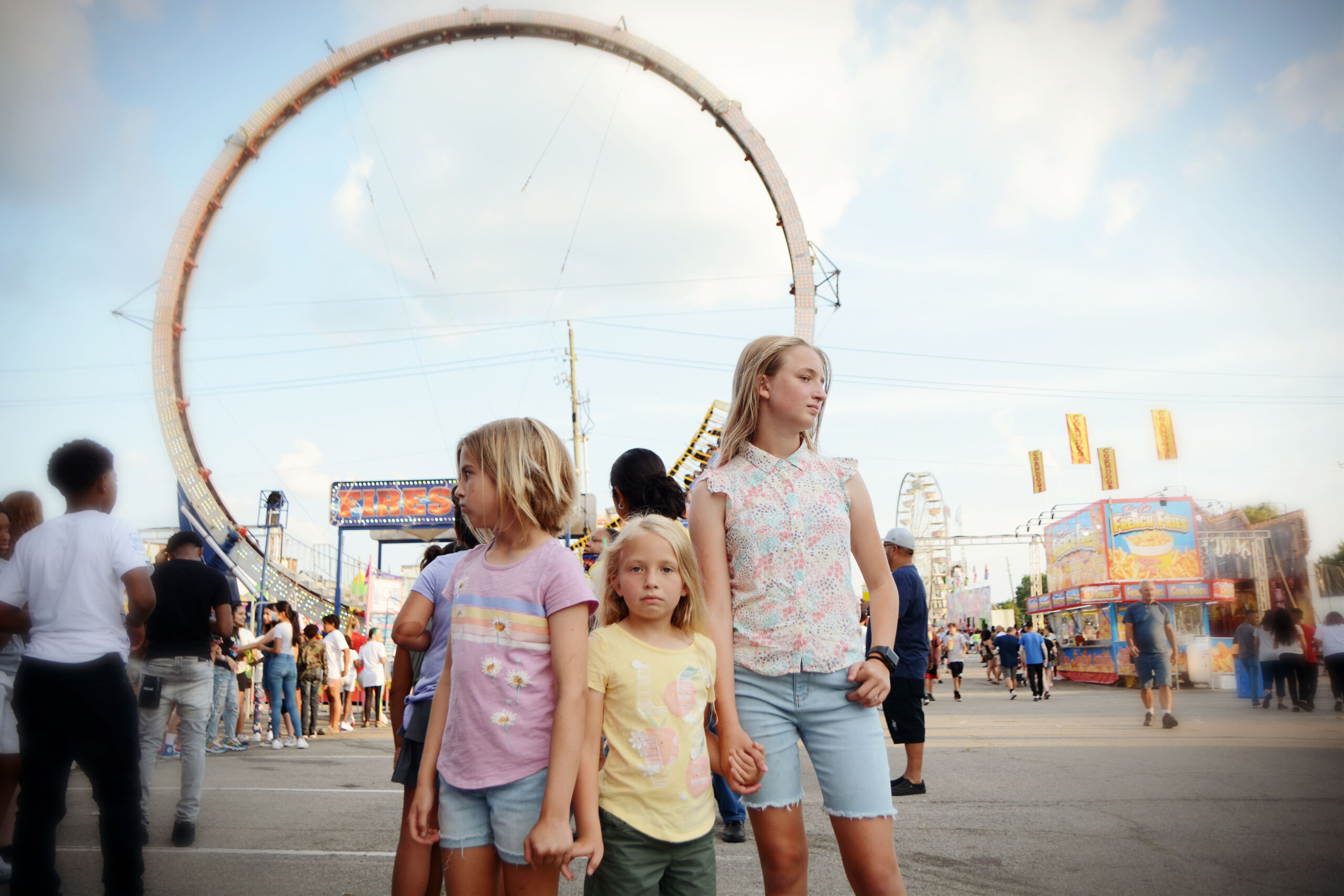 Three girls in front of ride at state fair
