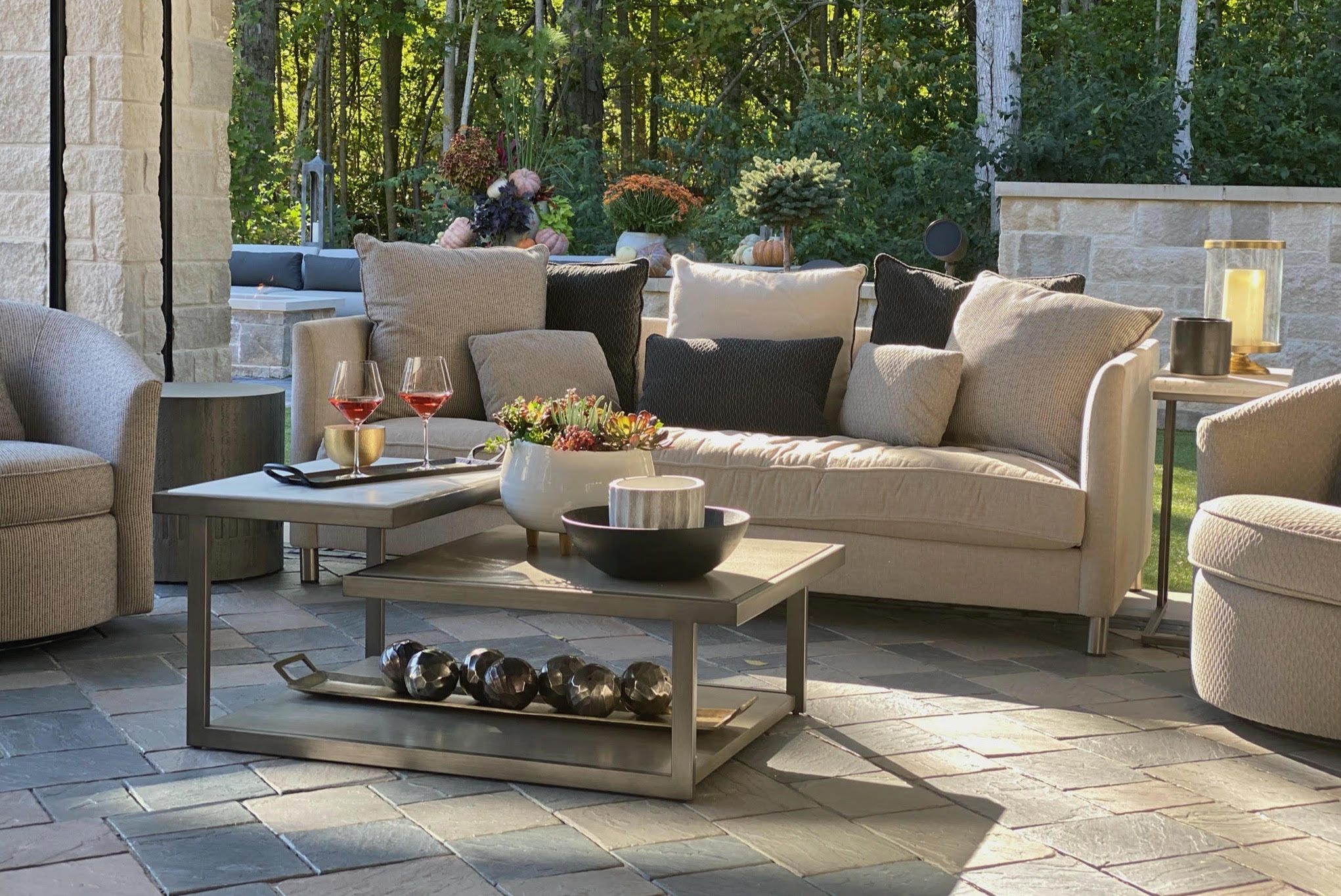 Outdoor space with tan couch and chair set
