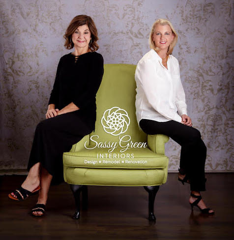 Headshot of owners leaning against green chair
