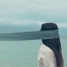 Woman with scarf around eyes