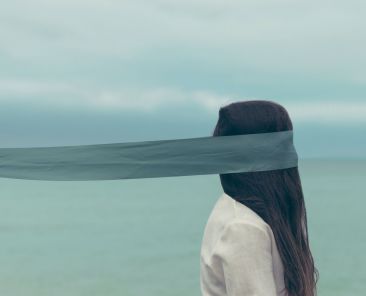 Woman with scarf around eyes