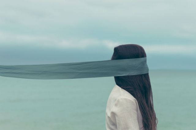 Woman with scarf around eyes