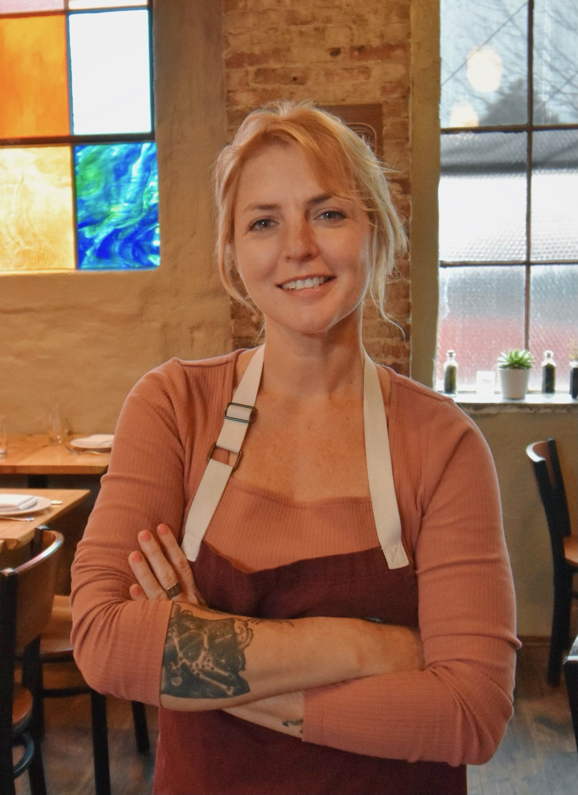 Headshot of owner wearing apron