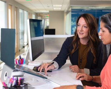 Two women working together at a computer
