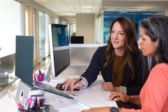 Two women working together at a computer