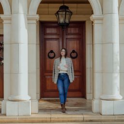 Women standing in front of entryway of a house