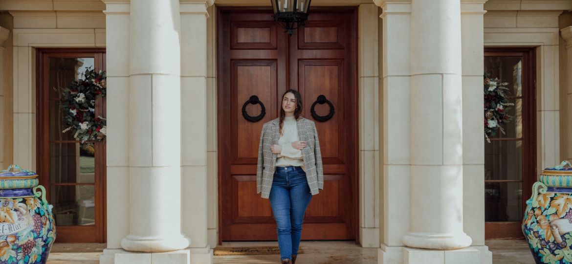 Women standing in front of entryway of a house