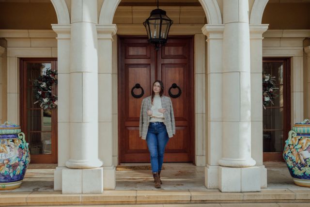 Women standing in front of entryway of a house