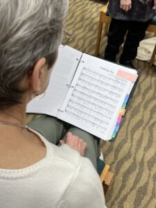Mary Pendexter reviews sheet music before a rehearsal of the Indianapolis Threshold Singers. The team often tries to find songs that will resonate with those they are ministering to. 