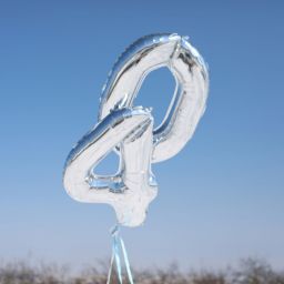 Silver number balloons "40" against blue sky.
