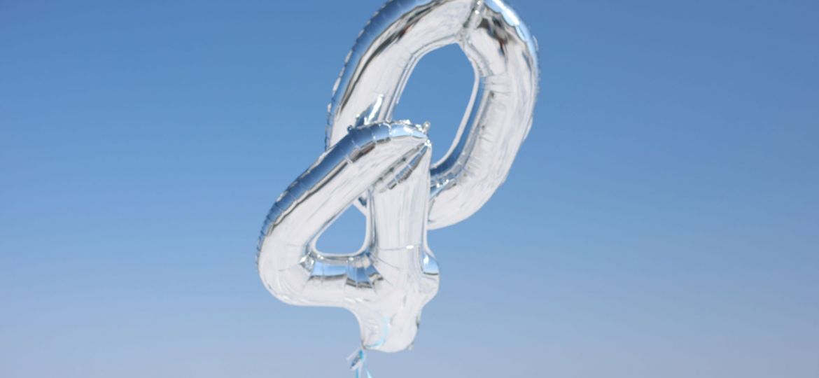 Silver number balloons "40" against blue sky.