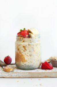 glass jar with overnight oats, strawberries and bananas