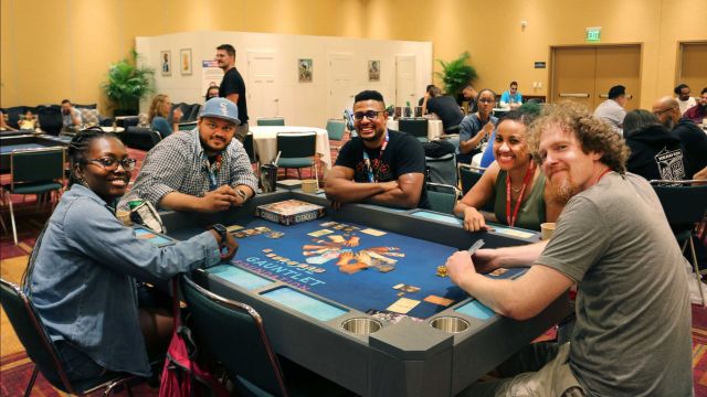 A group of people playing a game together at Gen Con.