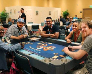 A group of people playing a game together at Gen Con.