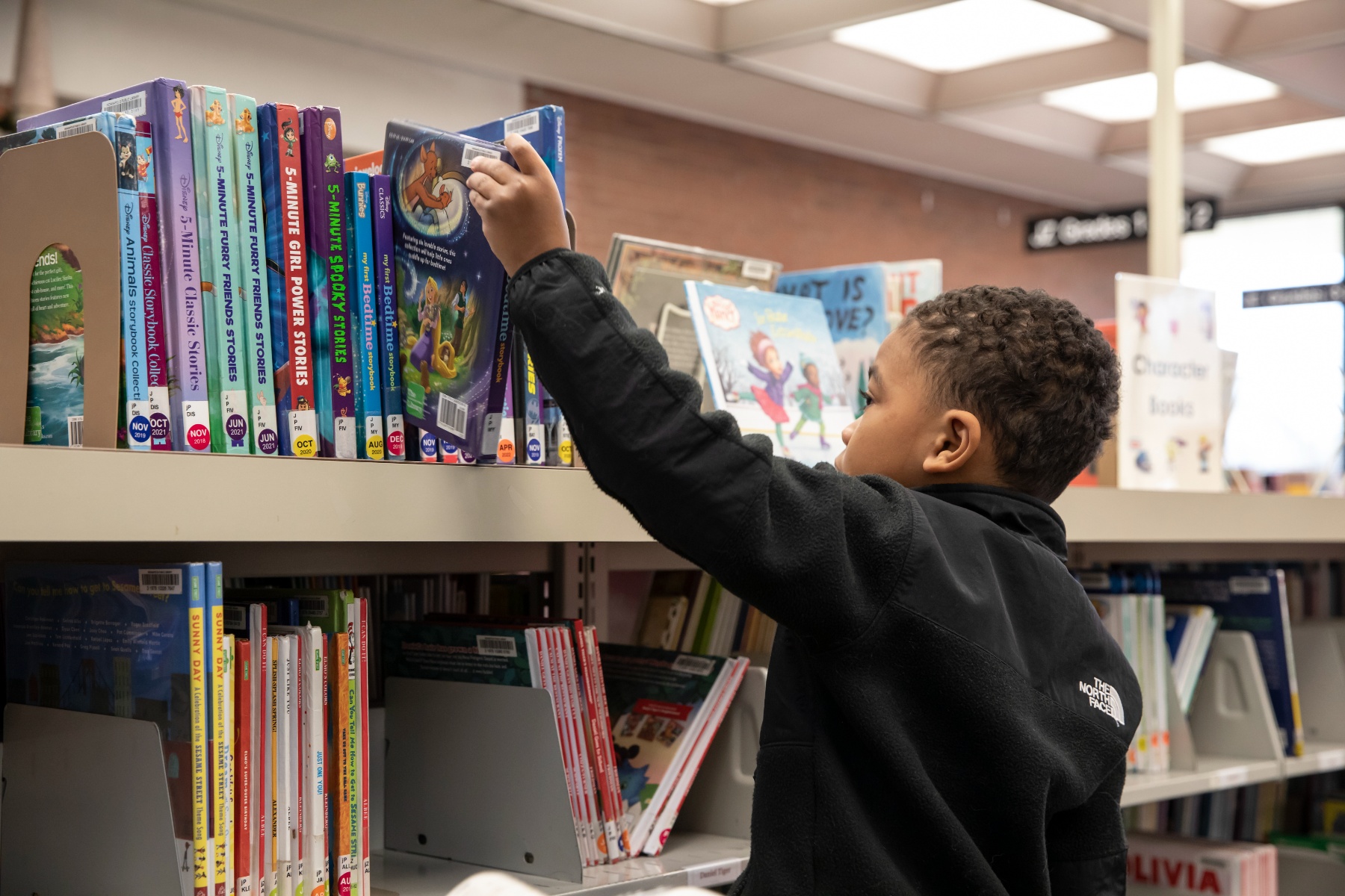 child picking out books at the Indianapolis Central Library