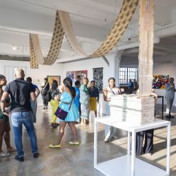 A small crowd gathering in a gallery at Butter 2023/photo cred. Eric Lubrick