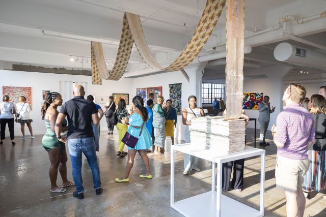 A small crowd gathering in a gallery at Butter 2023/photo cred. Eric Lubrick