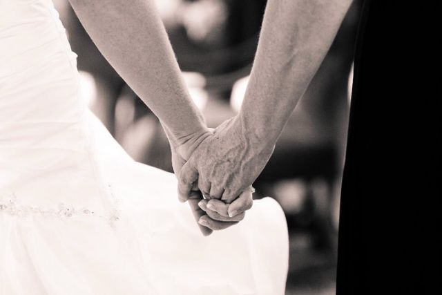 Chelsea holding hands with her mother.