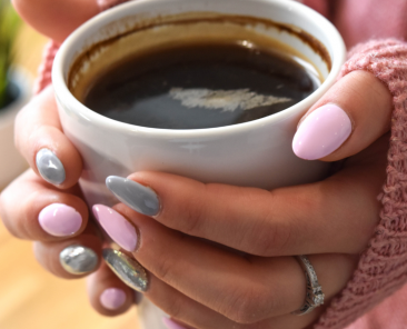 Black women's hands holding a cup of coffee