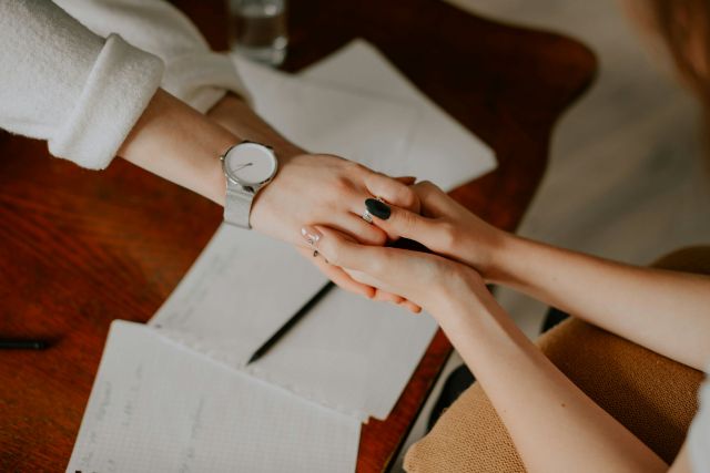 Two people holding hands.