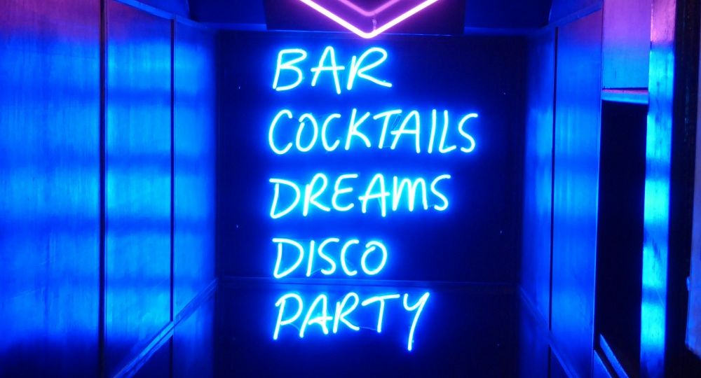 neon sign: Bar, Cocktails, Dreams, DIsco, Party