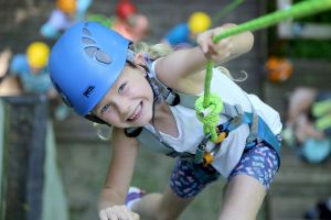 young girl climbing a wall