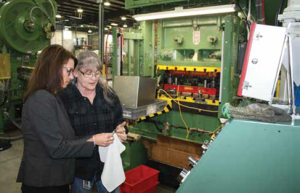 Susan Carlock speaking with a Mursix associate on the production floor.