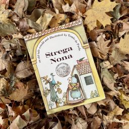 Strega Nona Book sitting on leaves.