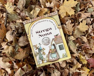 Strega Nona Book sitting on leaves.