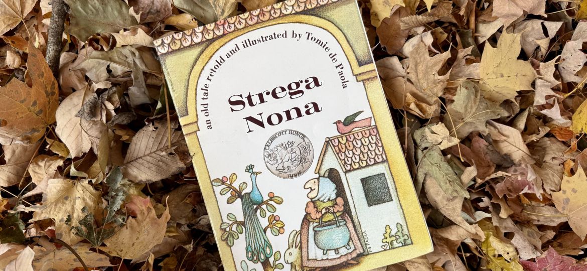 Strega Nona Book sitting on leaves.