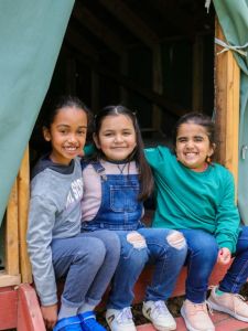 girl scouts hanging out in a cabin