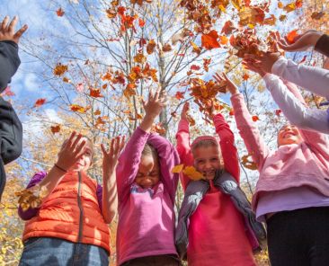 girls and women throwing leaves