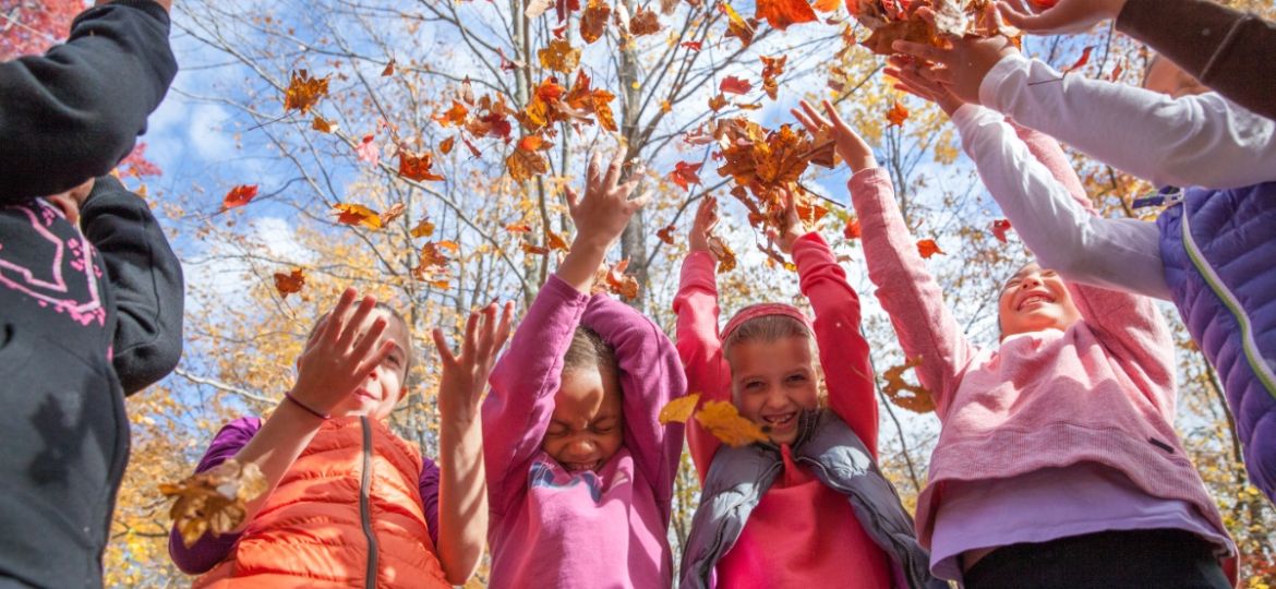 girls and women throwing leaves