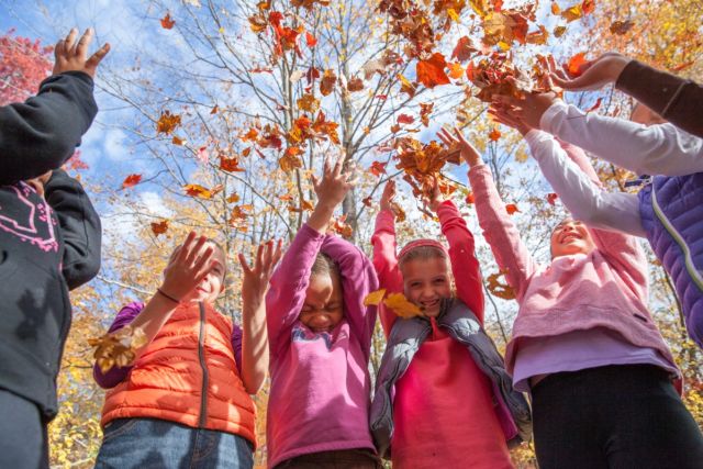 girls and women throwing leaves