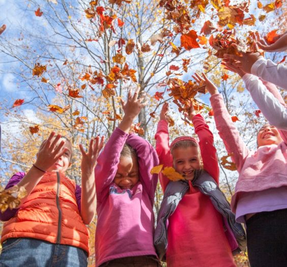 girls and women throwing leaves