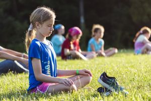 young girl practicing mindfulness outside