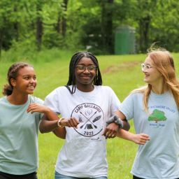 young women walking arm in arm