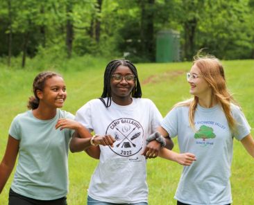 young women walking arm in arm