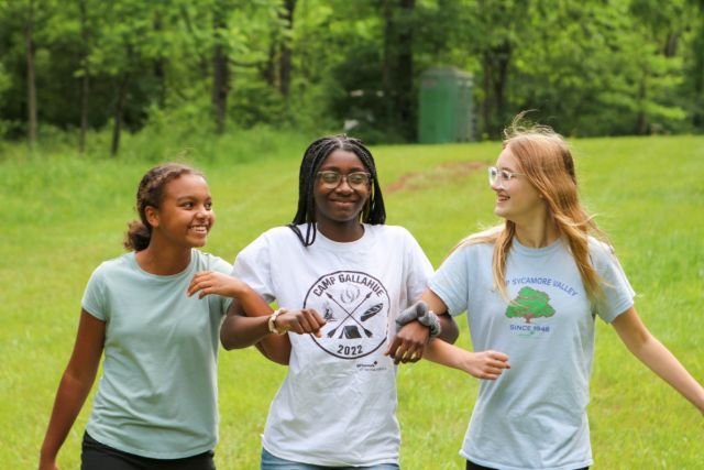 young women walking arm in arm