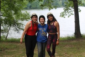 young women hanging out by a lake