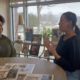 Arianna Cruz and Keianna Rae Harrison-Williams sitting at a table together talking.