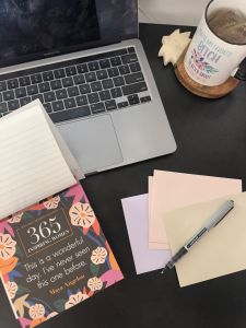 Laptop, calendar, and paper for reflection.