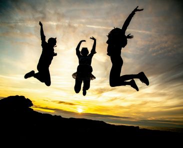 Mental Health Featured Image - Three people jumping in the air.