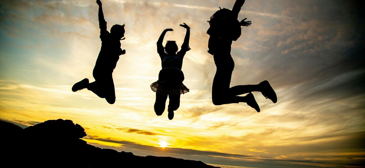Mental Health Featured Image - Three people jumping in the air.